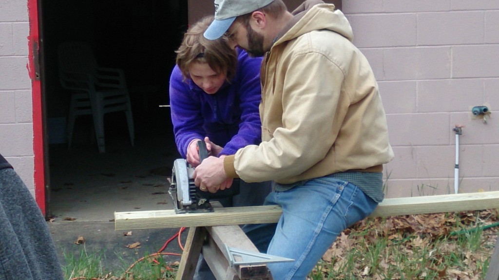 A camper learning to use a power tool