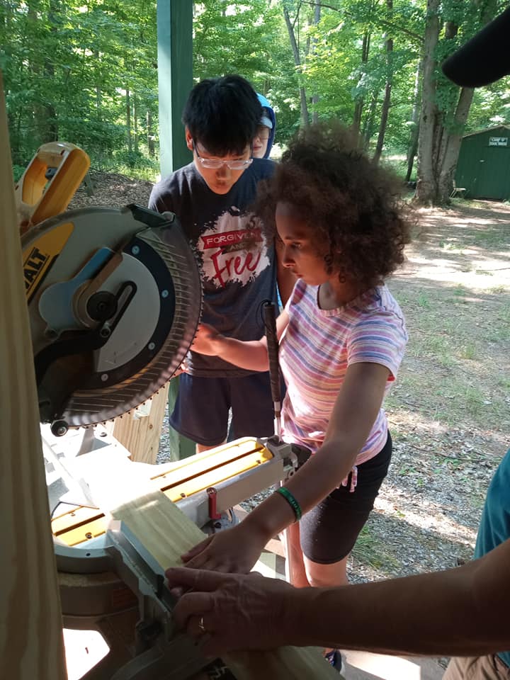 A camper learns to work a miter saw
