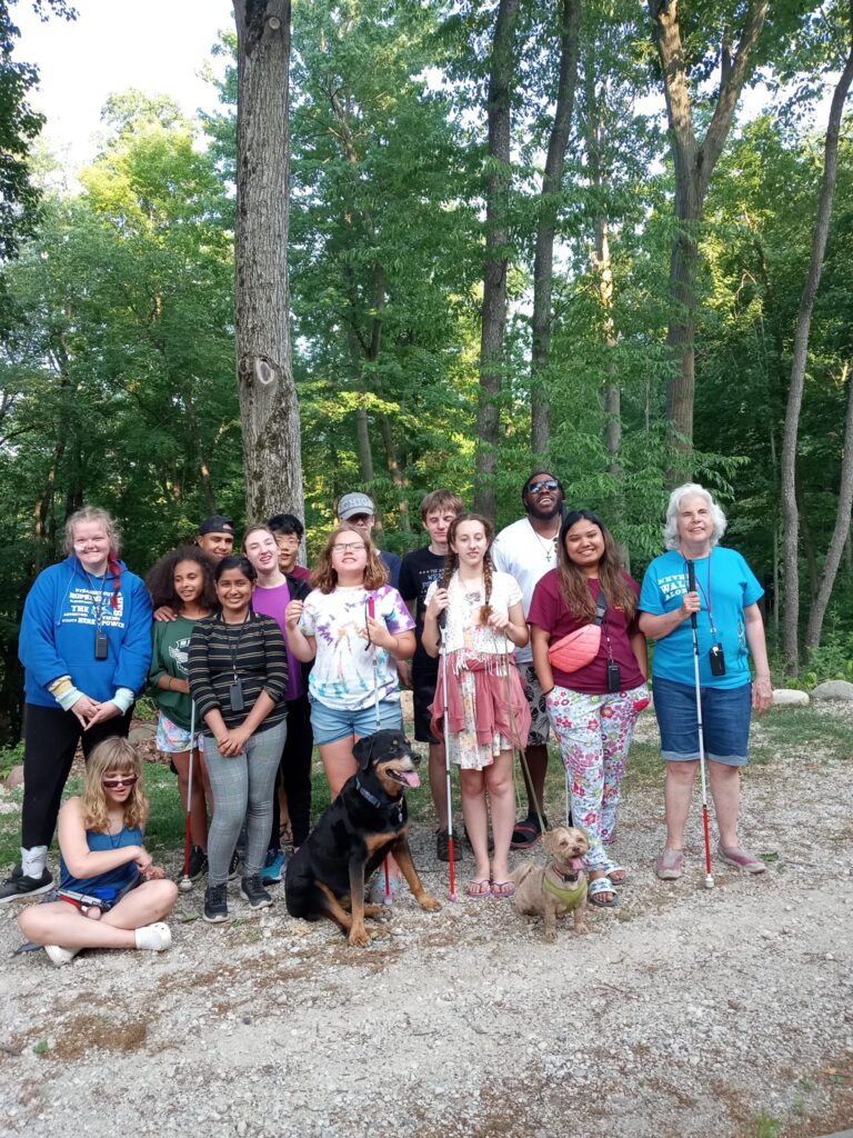 Campers posing for a picture in the woods