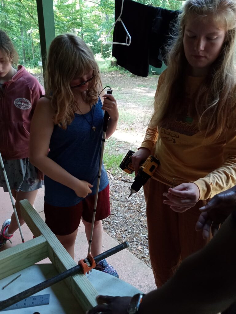 Campers learning about power tools